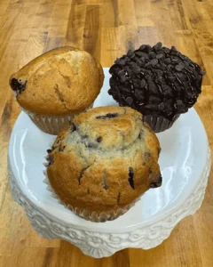 A logo of a cupcake with chocolate frosting.